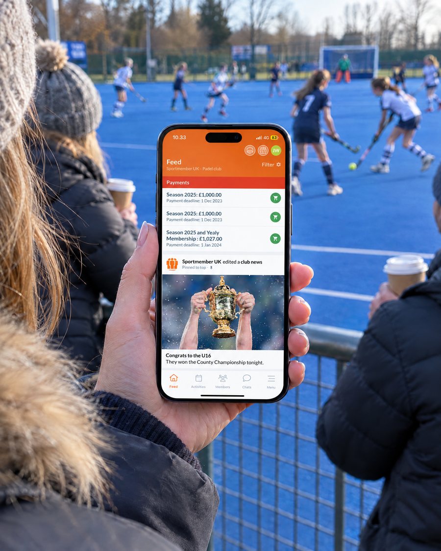 Parent at the side of the hockey pitch reading the club feed in the SportMember app